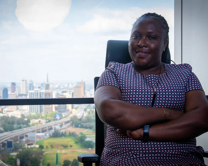 A professional in an office overlooking the Nairobi skyline