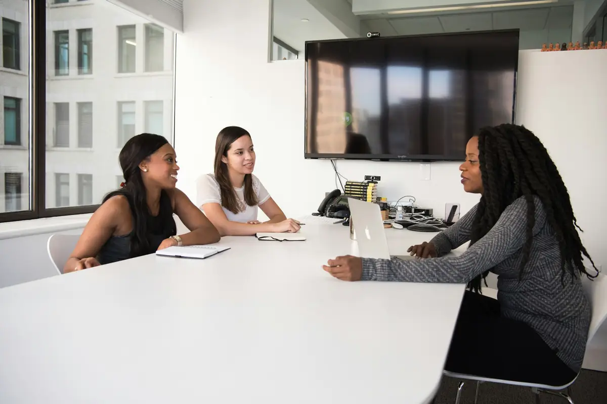 A hiring team talking through a role around a meeting table