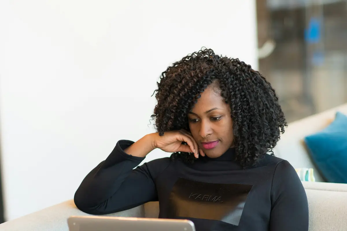 A professional working on a laptop in a quiet office lounge