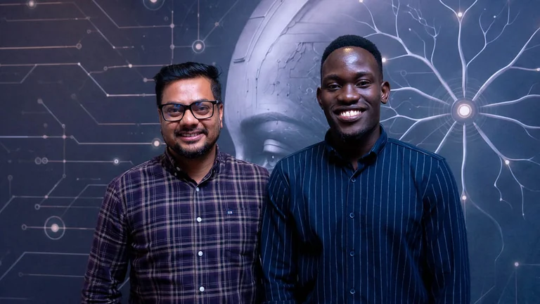 Two smiling colleagues standing together in an office