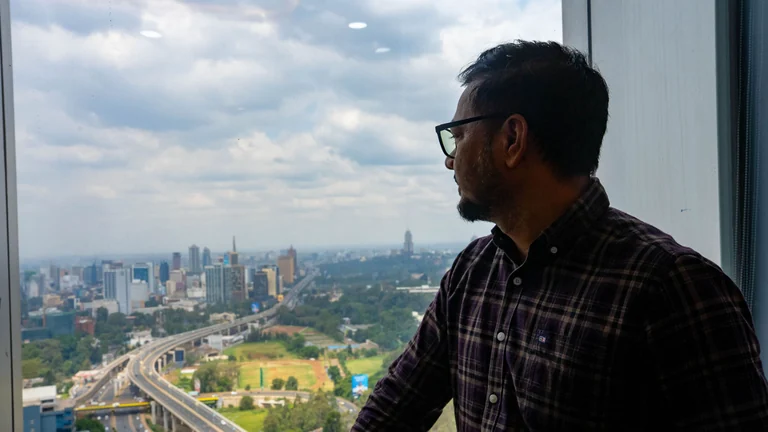 A professional looking out over the Nairobi skyline